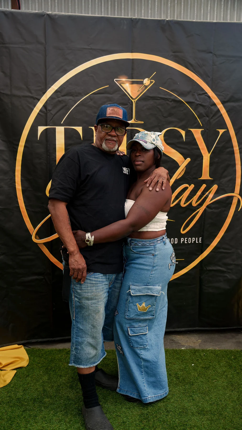 Guests in front of the Tipsy Sunday backdrop